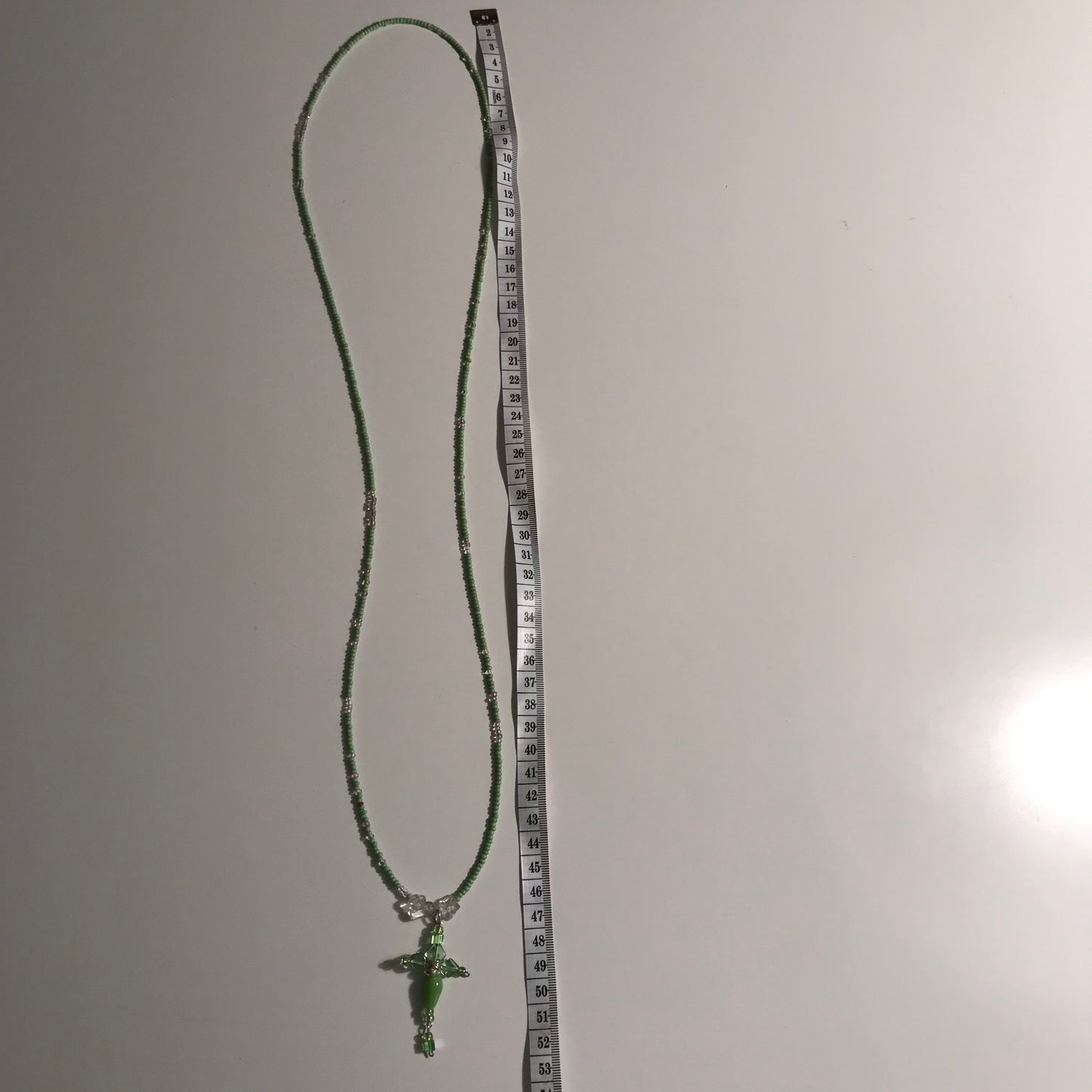 Halskæde i perler med grønt kors